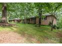 Brick home on a grassy lot surrounded by mature trees at 507 Richards Dr, Shelby, NC 28150