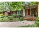 Inviting front porch with red door, brick steps, and landscaped garden at 507 Richards Dr, Shelby, NC 28150