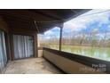 A cozy balcony overlooking a serene lake, perfect for relaxation and enjoying nature's beauty at 5718 Dockside Dr, Charlotte, NC 28227