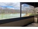 Balcony view to the lake with fountains, trees in background and frame view of balcony in foreground at 5718 Dockside Dr, Charlotte, NC 28227