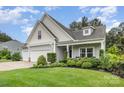 Lovely home with three-car garage, lush landscaping, and a welcoming front porch at 6309 Fawn Crest Dr, Waxhaw, NC 28173