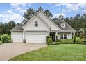 Charming home with three-car garage, manicured lawn, and inviting front porch at 6309 Fawn Crest Dr, Waxhaw, NC 28173