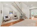 Bright foyer with a grand staircase, hardwood floors, and elegant decor, creating a welcoming entrance at 6831 Conservatory Ln, Charlotte, NC 28210