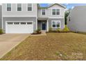 Well-maintained two-story home with a manicured front yard, a two-car garage, and inviting curb appeal at 703 Pointe Andrews Dr, Concord, NC 28025