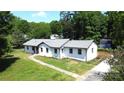 Charming single-story home with fresh exterior paint, mature trees, and spacious yard at 7101 City View Dr, Charlotte, NC 28212