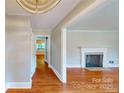 Spacious living room featuring hardwood floors, a fireplace, and a seamless open floor plan at 7101 City View Dr, Charlotte, NC 28212