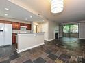 Open floor plan with a fireplace, large windows, and modern finishes, perfect for entertaining at 718 W Trade St, Charlotte, NC 28202