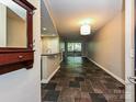 Open floor plan with slate flooring, light-colored walls, and access to a balcony or patio at 718 W Trade St, Charlotte, NC 28202