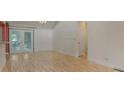 Bright living area features hardwood floors and leads to a patio through sliding glass doors at 7312 Barcliff Dr, Charlotte, NC 28212