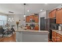 Well-lit kitchen boasts stainless steel appliances, granite countertops, and an open layout to the dining area at 8031 Scarlet Oak Ter, Indian Land, SC 29707
