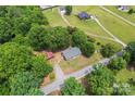 Aerial view of the property featuring lush greenery, mature trees, and a long driveway at 804 Gw Broome Rd, Monroe, NC 28112