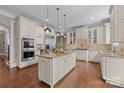 Bright, open kitchen with an island, stainless steel appliances, and granite countertops at 8701 Highgrove St, Charlotte, NC 28277