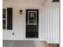 A close-up of the home's front door, featuring a window pane and a black finish at 894 Oval St, Kannapolis, NC 28081