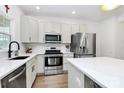 Well-lit kitchen featuring stainless steel appliances, quartz countertops, and stylish hardware at 9157 Snow Hill Ct, Charlotte, NC 28269