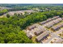 Aerial view of a residential community surrounded by lush green trees on a sunny day at 9203 Grand Valley Dr, Charlotte, NC 28213