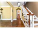 Inviting foyer with hardwood floors, a staircase, and arched doorway leading to other rooms at 1139 S Belvedere Ave, Gastonia, NC 28054