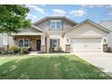 Charming single-Gathering home with a well-manicured lawn, inviting front porch, and two-car garage at 1244 Tranquil Falls Ln, Matthews, NC 28104