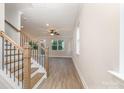 Open-concept living space with modern staircase and views of the exterior at 12744 Susanna Dr, Charlotte, NC 28214