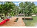 Wooden dock on a lake with space for a kayak and motorboat at 147 Bluewing Ln # 274, Mooresville, NC 28117