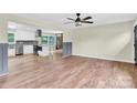 Open living room showcasing hardwood floors and recessed lighting leading to the modern kitchen at 1501 E Church St, Cherryville, NC 28021