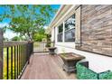 Charming front porch has decorative wood toned shutters, potted plants and wood railing at 1501 E Church St, Cherryville, NC 28021