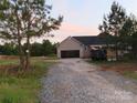 New construction home with attached garage and a welcoming, covered front porch at 153 Mason Tanner Ct, Rock Hill, SC 29730