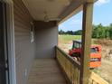 View of a cozy front porch with ceiling fan and wood railing, perfect for relaxing outdoors at 153 Mason Tanner Ct, Rock Hill, SC 29730