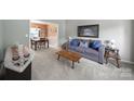 Comfortable living room with neutral carpet, sofa, coffee table, and view into the adjacent dining room at 2017 White Cedar Ln, Waxhaw, NC 28173
