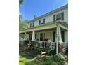 Two-story home with a large front porch at 208 E Main St, Cleveland, NC 27013