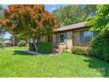 Beautifully landscaped front yard of a well-maintained brick home, with inviting curb appeal at 232 Scottridge Dr, Charlotte, NC 28217