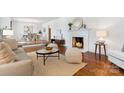 Bright and airy living room with hardwood floors, fireplace, and seamless flow to the dining area at 232 Scottridge Dr, Charlotte, NC 28217