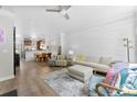 Bright living room featuring shiplap wall, ceiling fan, recessed lights and an open floor plan at 2485 Shanklin Ln, Denver, NC 28037