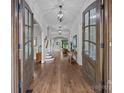 Grand foyer featuring hardwood floors, elegant lighting, and stunning wood-framed glass doors at 270 Kemp Rd, Mooresville, NC 28117