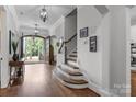 Open foyer with hardwood floors, staircase, and views to the exterior at 270 Kemp Rd, Mooresville, NC 28117