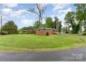 Sprawling red brick home with a manicured lawn and mature trees, showcasing classic suburban charm at 2885 Wright Ave, Salisbury, NC 28147