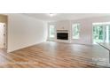 Spacious living room boasts a modern fireplace, ample natural light, and beautiful wood flooring at 3229 Bozeman Ct # 13, Stanley, NC 28164