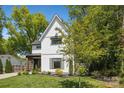 Charming two-story home with a well-kept lawn, framed by mature trees at 324 Elm St, Belmont, NC 28012