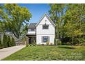 Inviting two-story home with manicured lawn, surrounded by lush green trees on a sunny day at 324 Elm St, Belmont, NC 28012