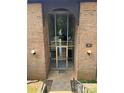 Welcoming entrance, showcasing a glass door and brick archway, inviting visitors inside at 415 Orchard Trace Ln # 1, Charlotte, NC 28213