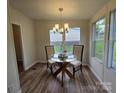 Cozy dining area featuring a round table with glass top and elegant chandelier lighting at 5010 Hemphill Rd, Gastonia, NC 28056