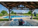 Relaxing poolside view with covered patio, outdoor ceiling fan, and backyard at 5873 Alexis Ln, Vale, NC 28168