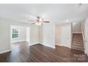 Bright living room with hardwood floors, a ceiling fan, and a view into a dining area at 668 Smith St, Kannapolis, NC 28083