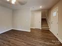 Inviting living room featuring modern wood-style floors, stairway, and neutral wall paint at 668 Smith St, Kannapolis, NC 28083
