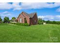 Well-maintained brick home with lush green lawn and mature trees at 8520 Wright Rd, Kannapolis, NC 28081