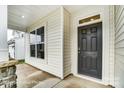 An inviting front entrance with a black door, stone accents, and a covered porch at 8619 Frank Grier Rd # 3, Charlotte, NC 28215
