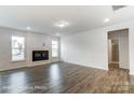 Spacious living room with dark hardwood floors, a cozy fireplace, and plenty of natural light at 8619 Frank Grier Rd # 3, Charlotte, NC 28215