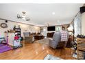 Cozy living room featuring hardwood floors, comfortable seating, and ample natural light at 907 Sikes Mill Rd, Monroe, NC 28110