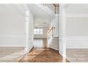 Inviting foyer featuring hardwood floors, a staircase, and wainscoting at 10008 King George Ln, Waxhaw, NC 28173