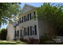 Beautiful two-story home with classic shutters and lovely landscaping at 10434 Blackstock Rd, Huntersville, NC 28078