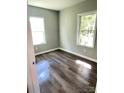 Sun-drenched bedroom features updated flooring and modern windows, offering a cozy retreat at 1052 S Grove Street Ext, Lincolnton, NC 28092